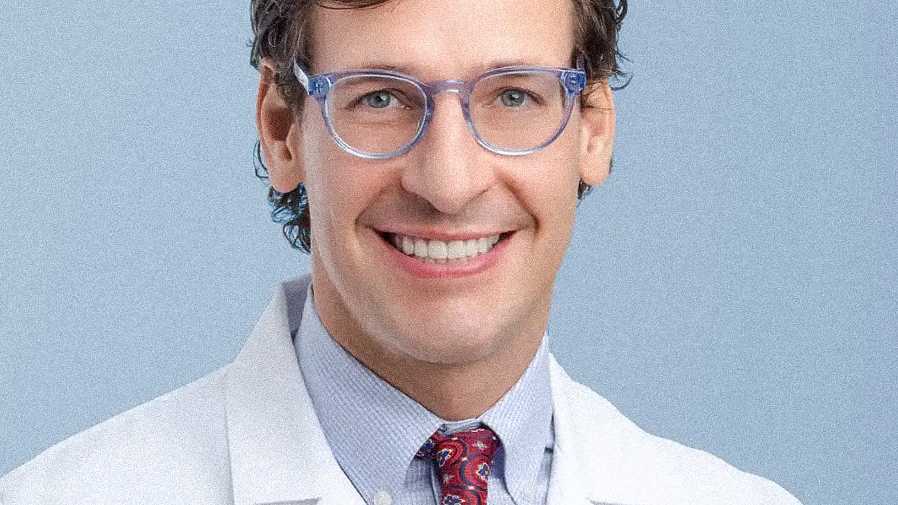 Physician in white coat photographed for doctor headshots in a Miami studio