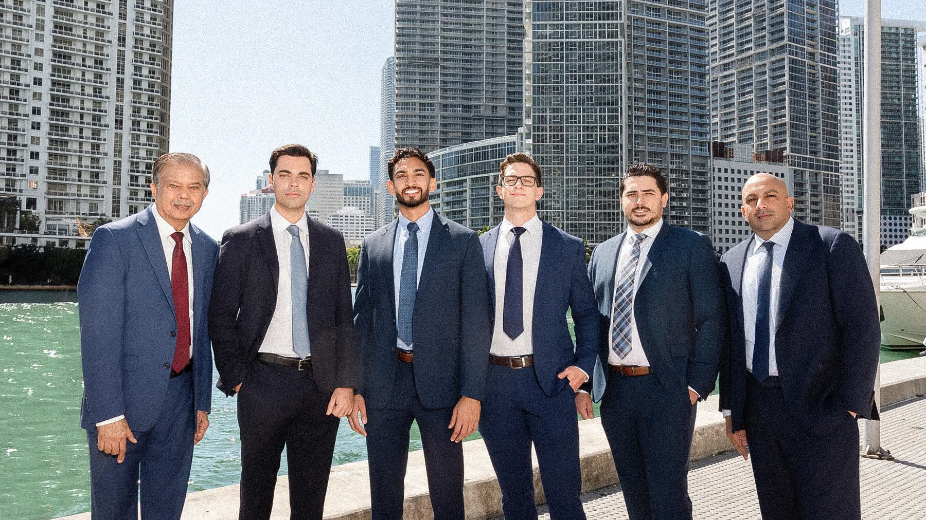 A row of real estate agents photographed for matching real estate team headshots in Miami