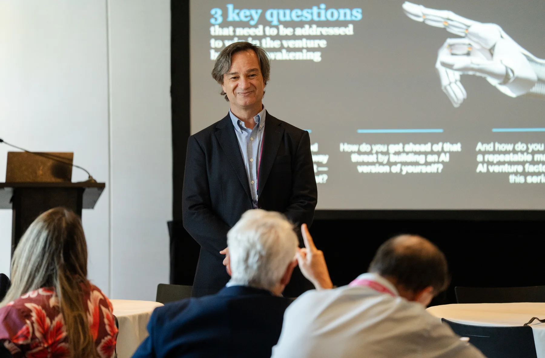 Corporate presenter standing in front of AI conference slides