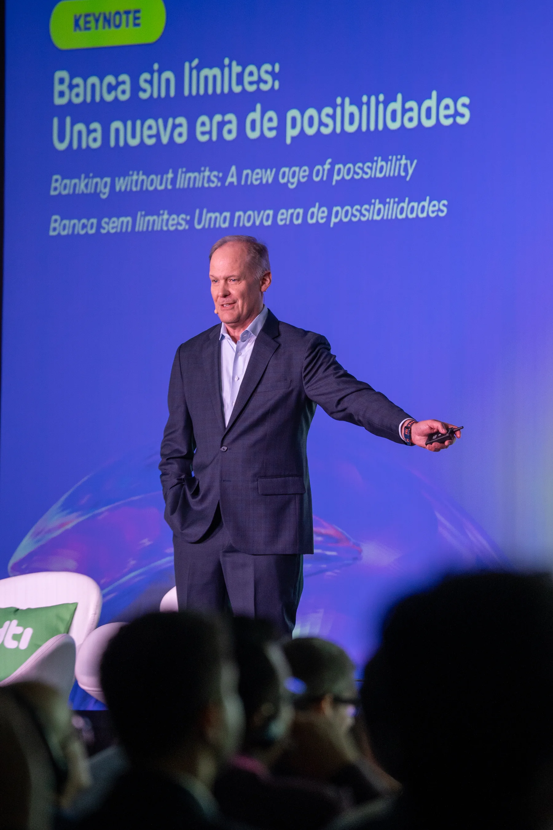 Vertical keynote photograph with blue branded event screen